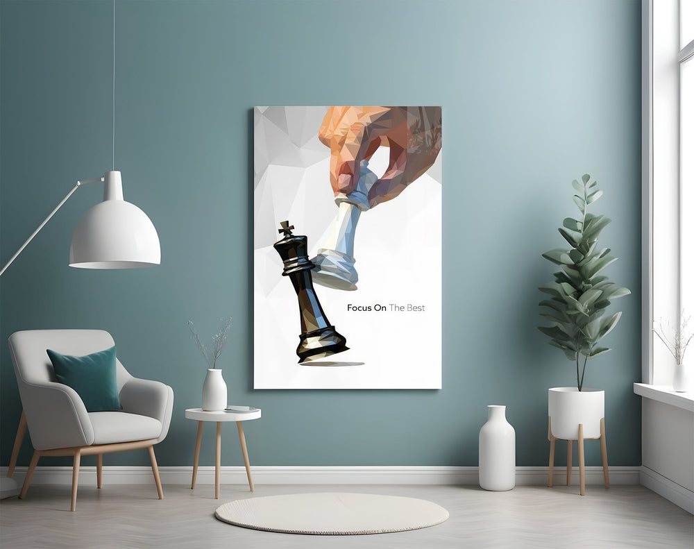 low-poly hand toppling a chess king glass wall art styled above an armchair in a reading corner