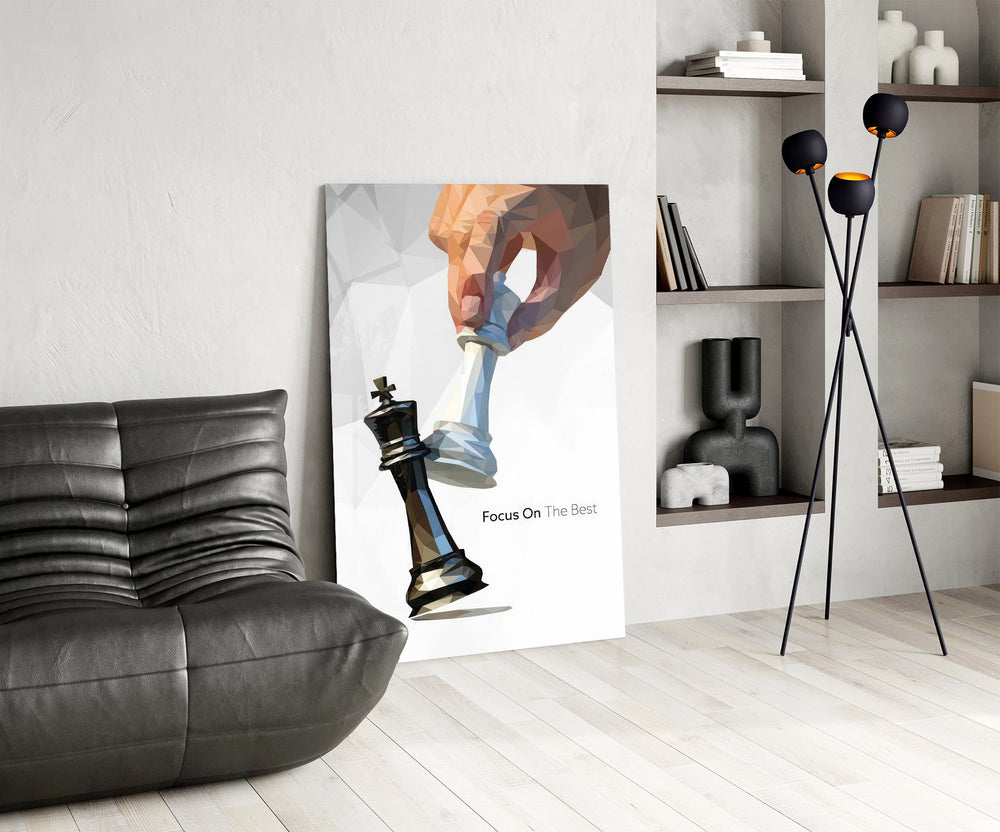 low-poly hand toppling a chess king glass wall art leaning beside a dark leather sofa