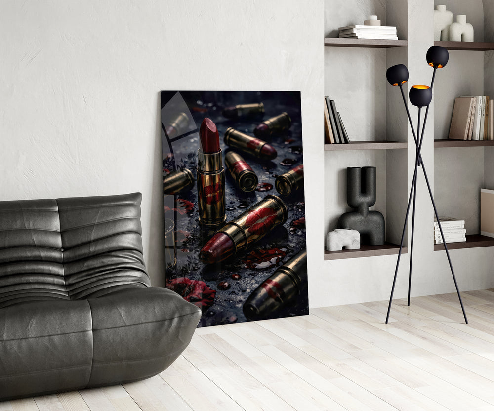 red lipstick among brass bullet casings glass wall art leaning beside a dark leather sofa