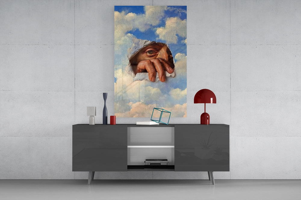 an eye and hand breaking through a painted sky glass wall art displayed above a console in a designer interior