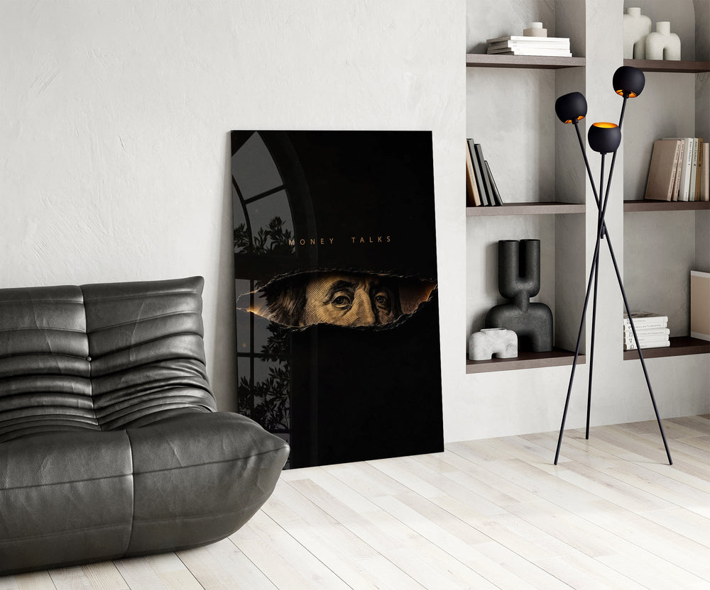 money talks torn dollar bill eyes glass wall art leaning beside a dark leather sofa