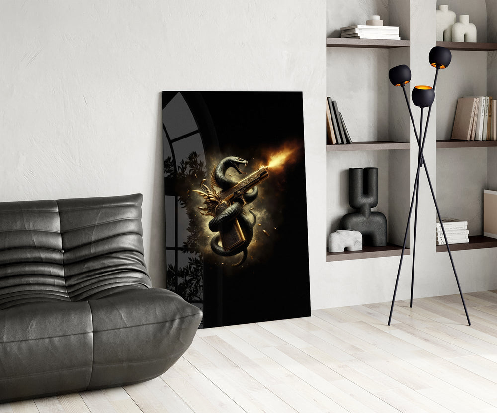golden pistol wrapped by a black serpent glass wall art leaning beside a dark leather sofa