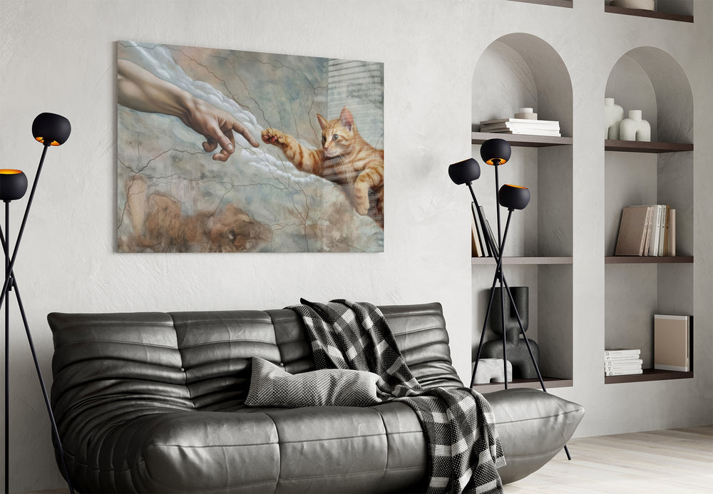 ginger kitten reaching a paw to a human hand glass wall art styled above an armchair in a reading corner