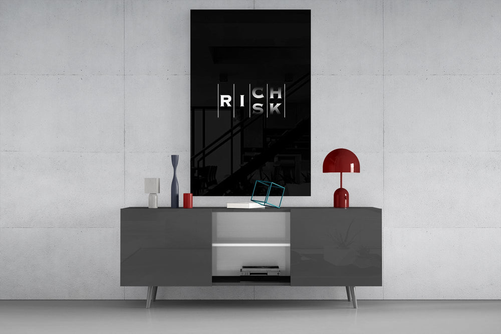 interlocking rich and risk typography glass wall art displayed above a console in a designer interior