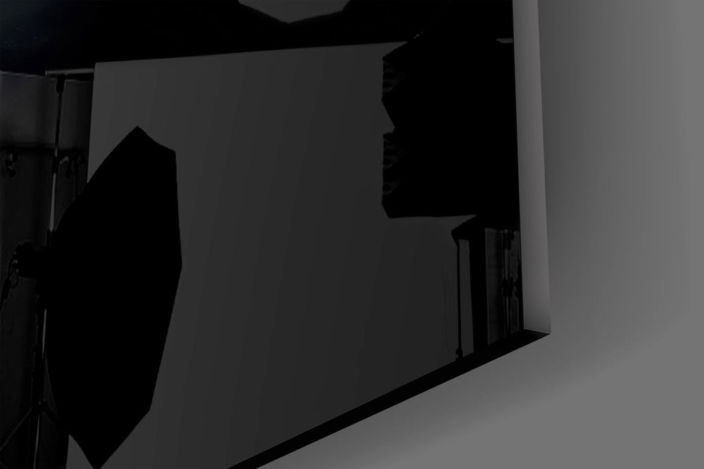 Close-up detail of the muzzle flash and spent casings against black smoke on the glass surface