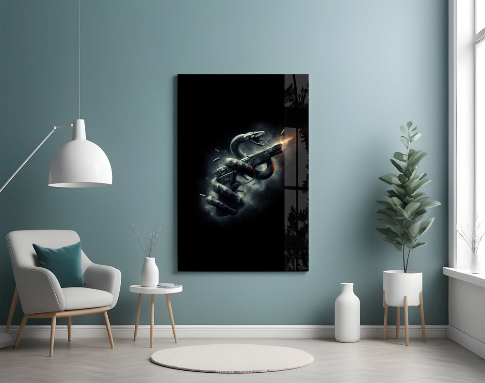 a serpent coiled around a firing pistol glass wall art styled above an armchair in a reading corner