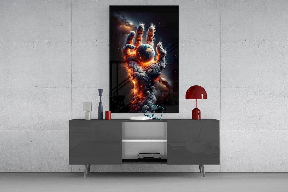 a hand of smoke and fire cradling planet earth glass wall art displayed above a console in a designer interior
