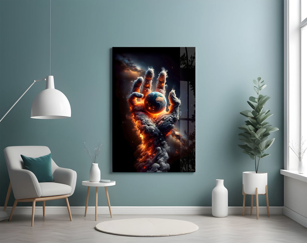 a hand of smoke and fire cradling planet earth glass wall art styled above an armchair in a reading corner