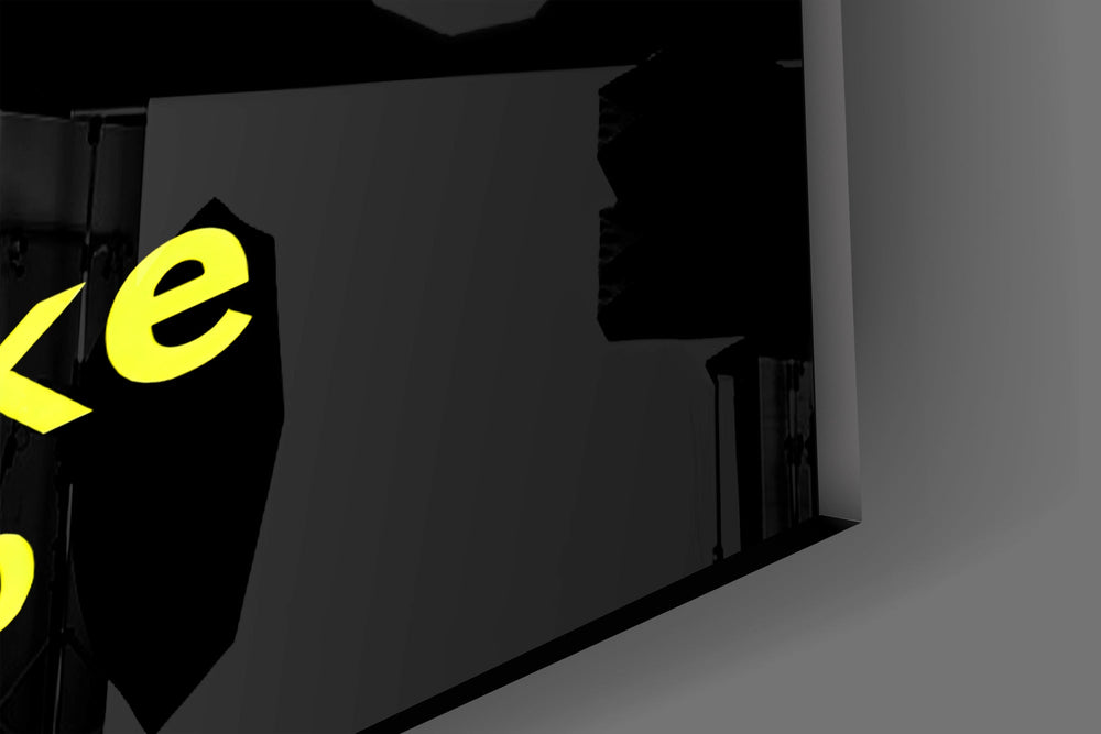Close-up detail of the yellow type threaded along thin vertical lines on the glass surface