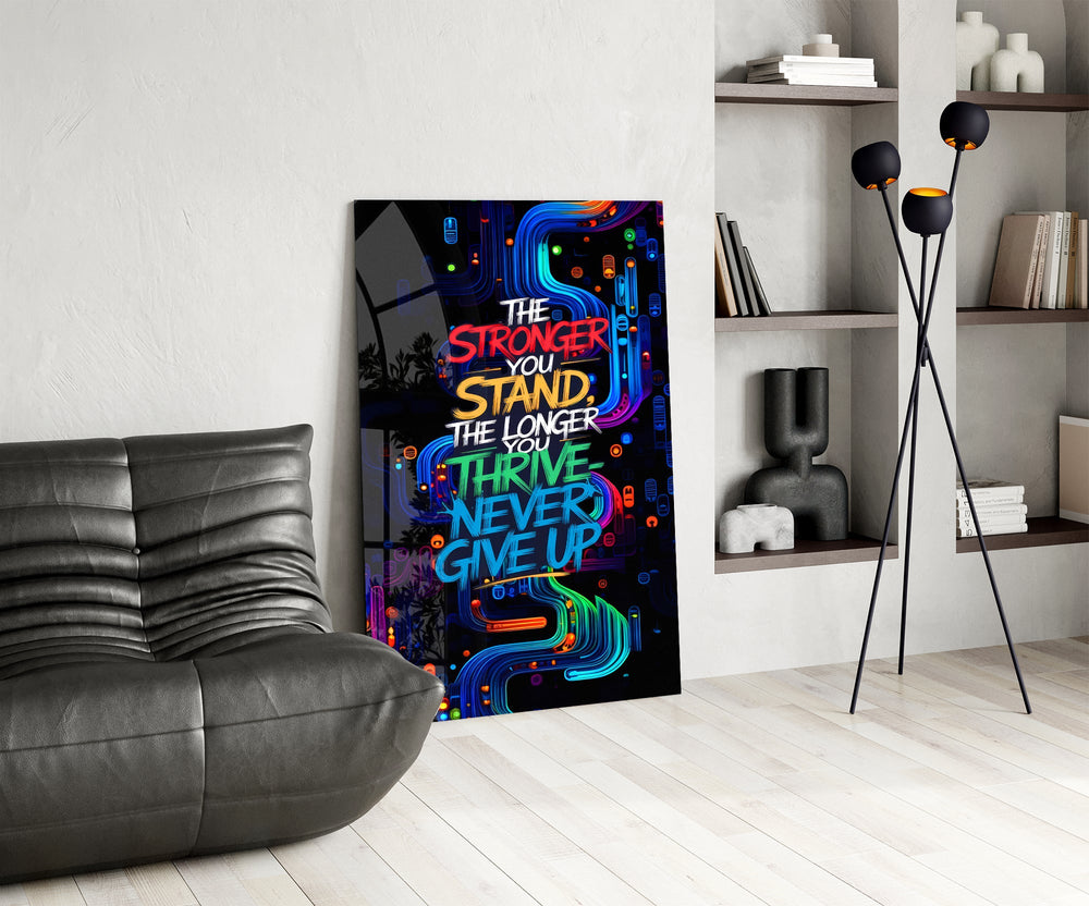 never give up neon graffiti quote glass wall art leaning beside a dark leather sofa