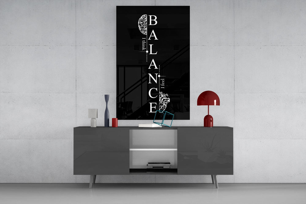 balance brain and heart quote glass wall art displayed above a console in a designer interior