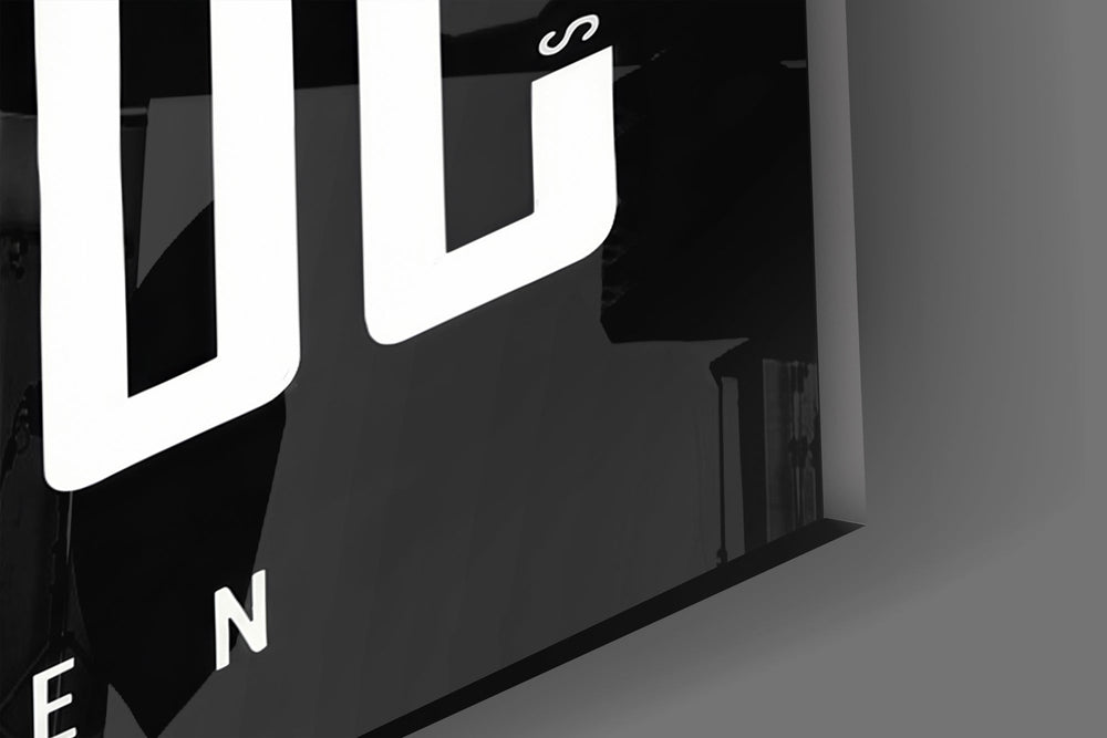 Close-up detail of the towering condensed capitals and the hidden hustle mottos woven through them on the glass surface