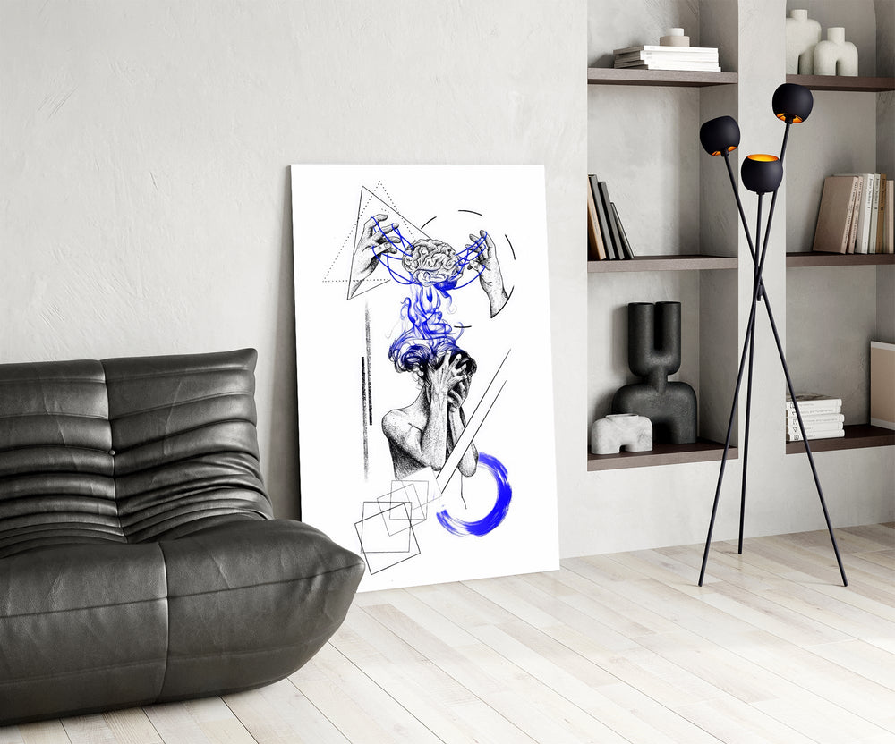 brain unravelling into blue threads glass wall art leaning beside a dark leather sofa