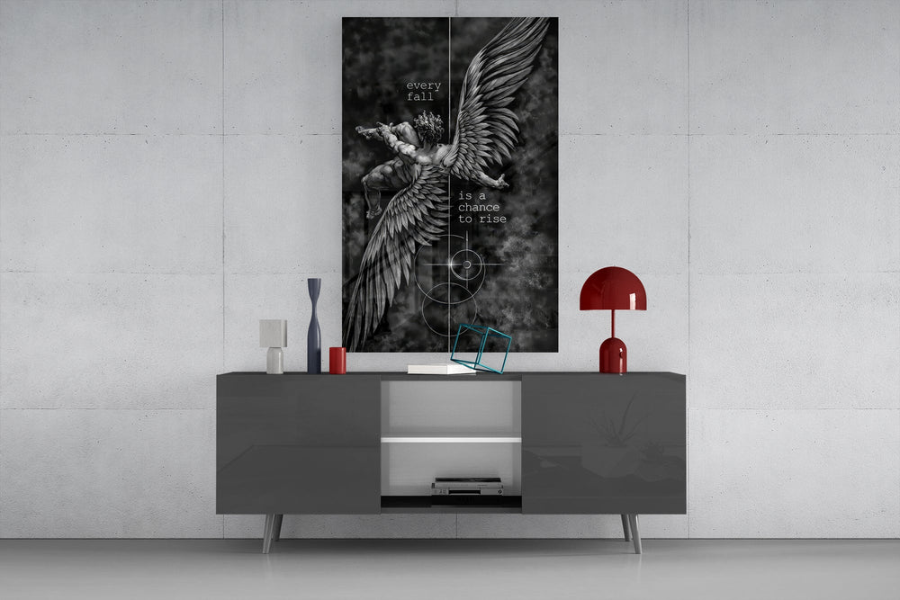 winged figure every fall to rise glass wall art displayed above a console in a designer interior