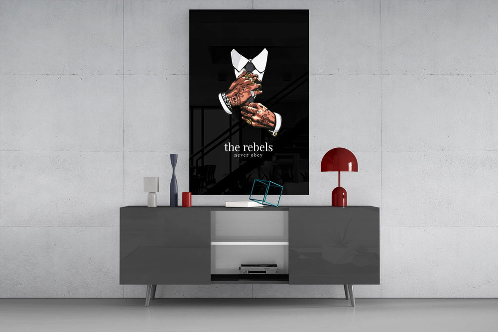 tattooed hands and the words the rebels never obey glass wall art displayed above a console in a designer interior