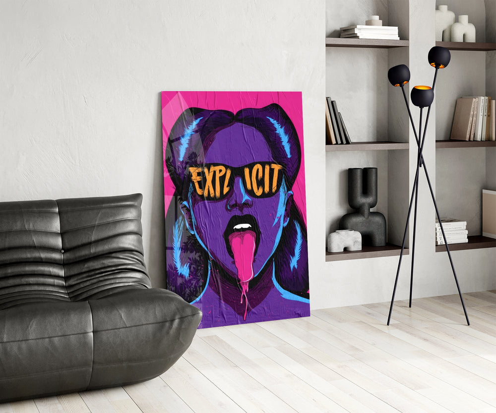 explicit pop art woman in sunglasses glass wall art leaning beside a dark leather sofa