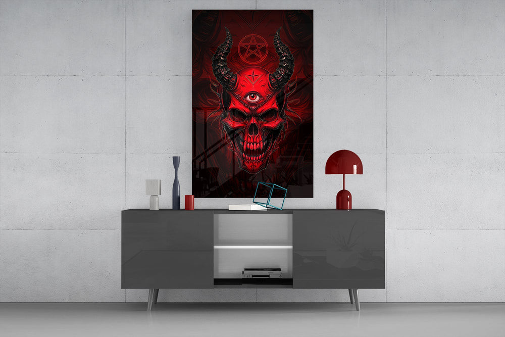 a red horned skull with a third eye glass wall art displayed above a console in a designer interior