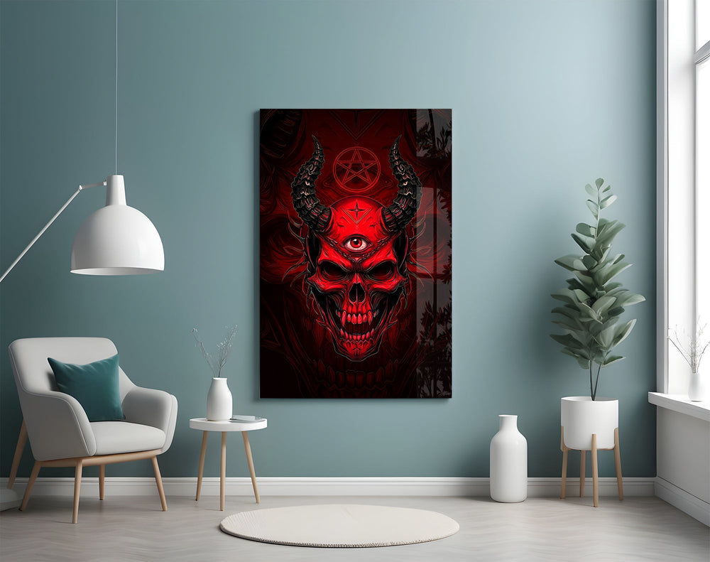 a red horned skull with a third eye glass wall art styled above an armchair in a reading corner