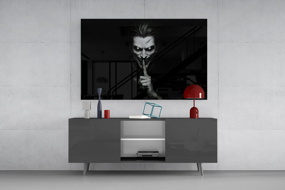a grinning pale figure calling for silence glass wall art displayed above a console in a designer interior