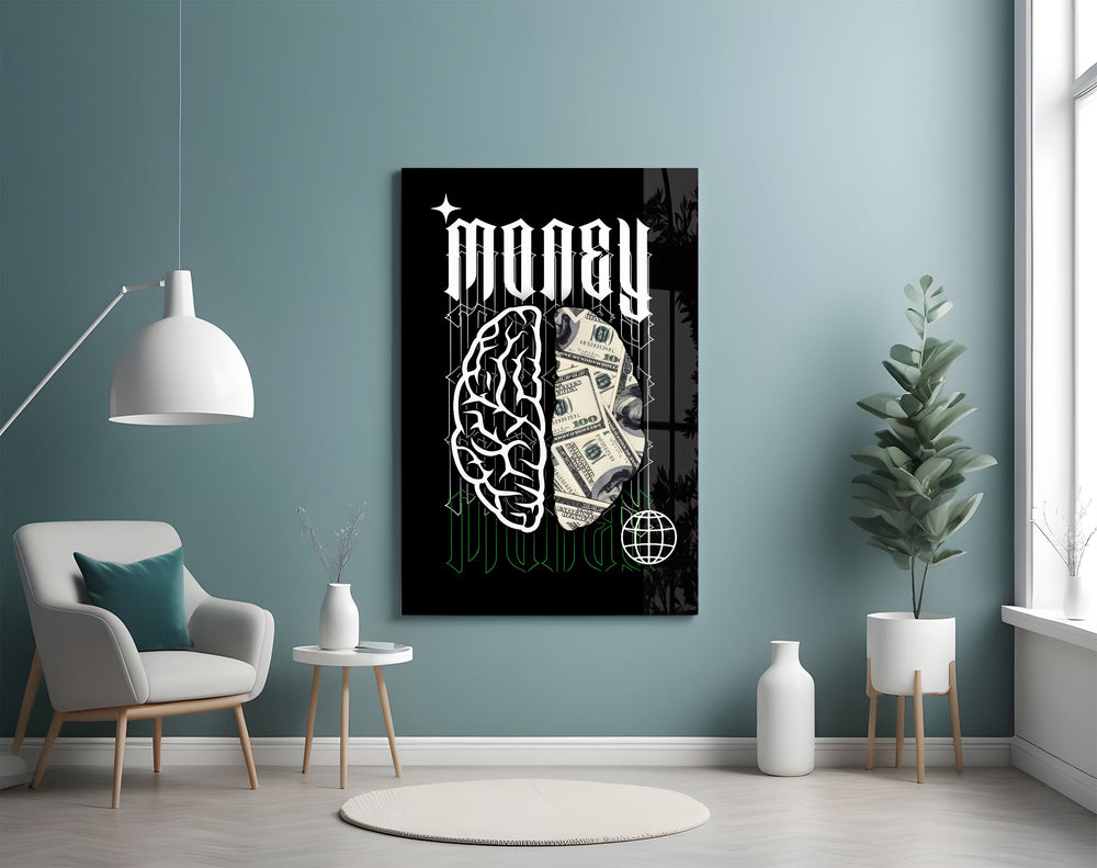 a brain half built from hundred-dollar bills glass wall art styled above an armchair in a reading corner