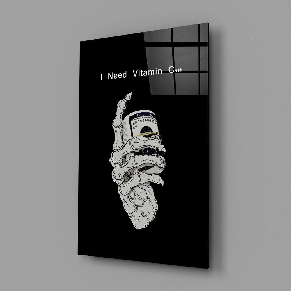 a skeleton hand gripping a roll of cash glass wall art angled to show the polished tempered glass panel