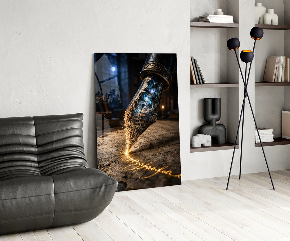 a fountain pen nib holding a cosmic amphitheatre glass wall art leaning beside a dark leather sofa