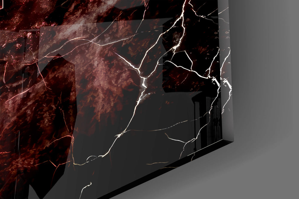 Close-up detail of the glowing red fissures behind the chrome letters on the glass surface