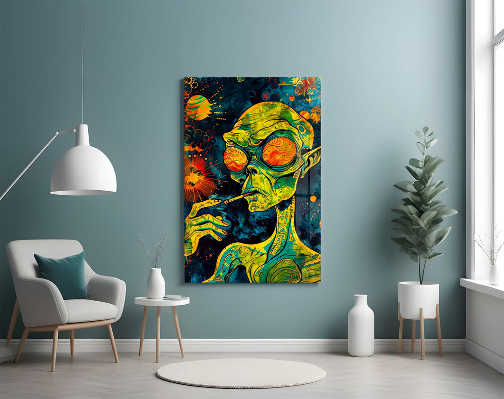 green alien smoking in deep space glass wall art styled above an armchair in a reading corner
