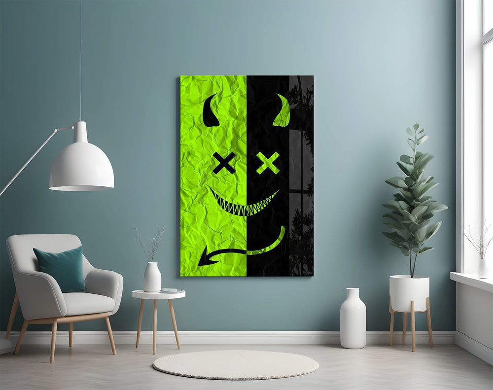 split neon green devil smiley glass wall art styled above an armchair in a reading corner