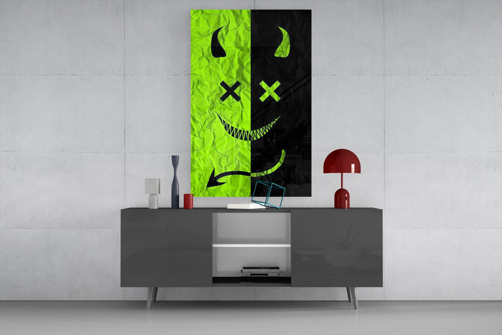 split neon green devil smiley glass wall art displayed above a console in a designer interior