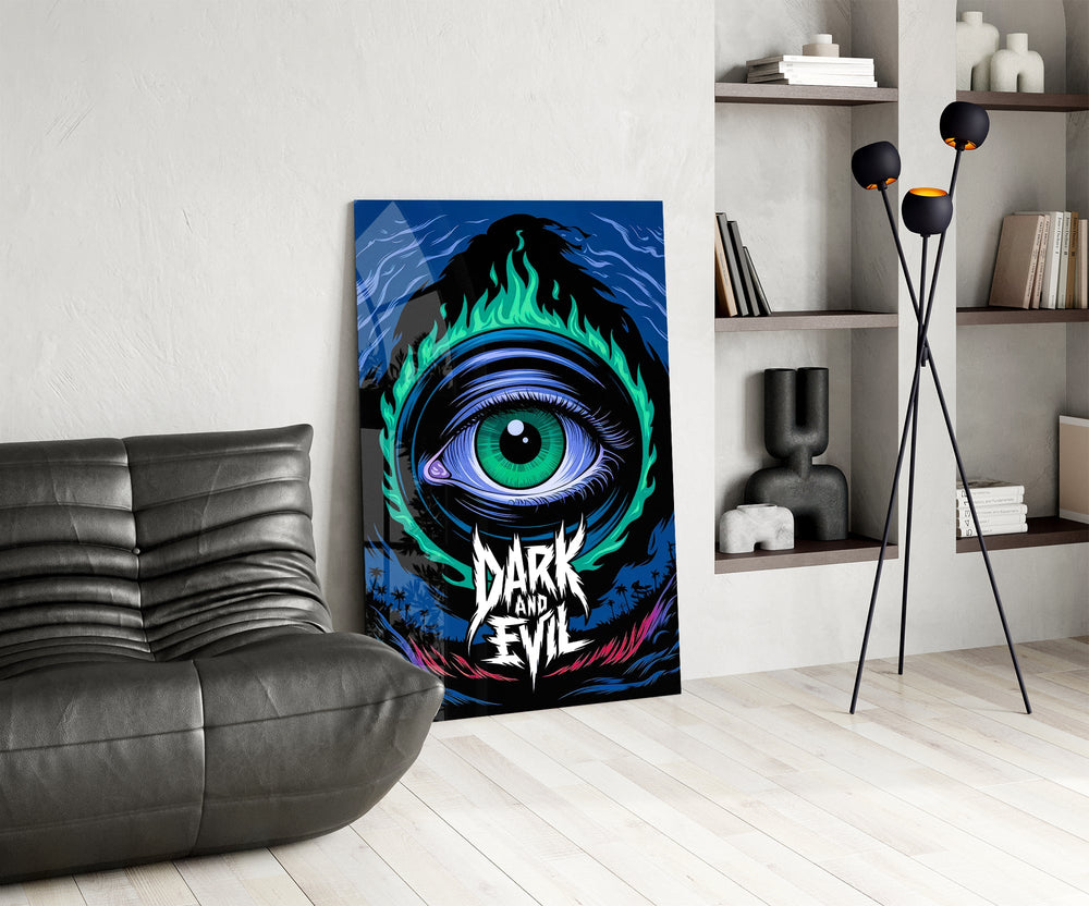 green flame eye over a night coastline glass wall art leaning beside a dark leather sofa