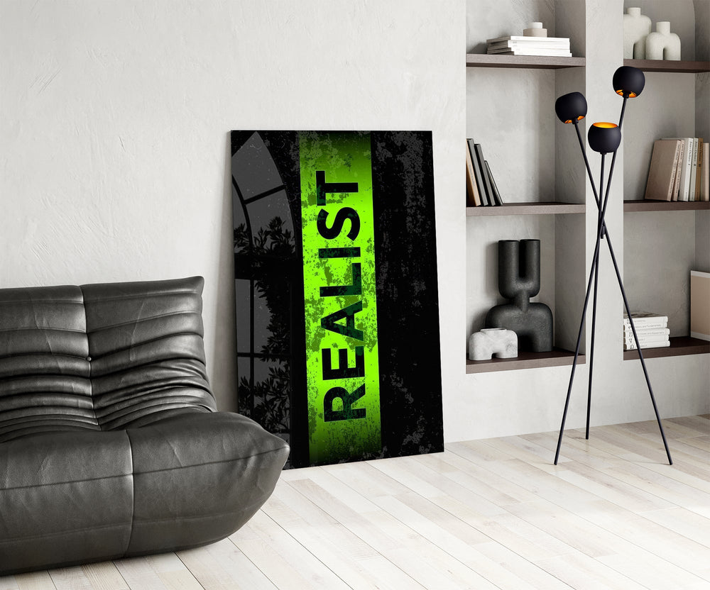 acid green stencil band on distressed black glass wall art leaning beside a dark leather sofa