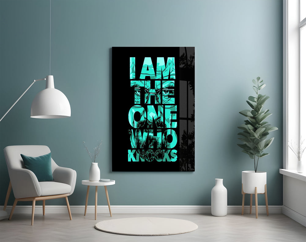 turquoise word stack hiding a face glass wall art styled above an armchair in a reading corner