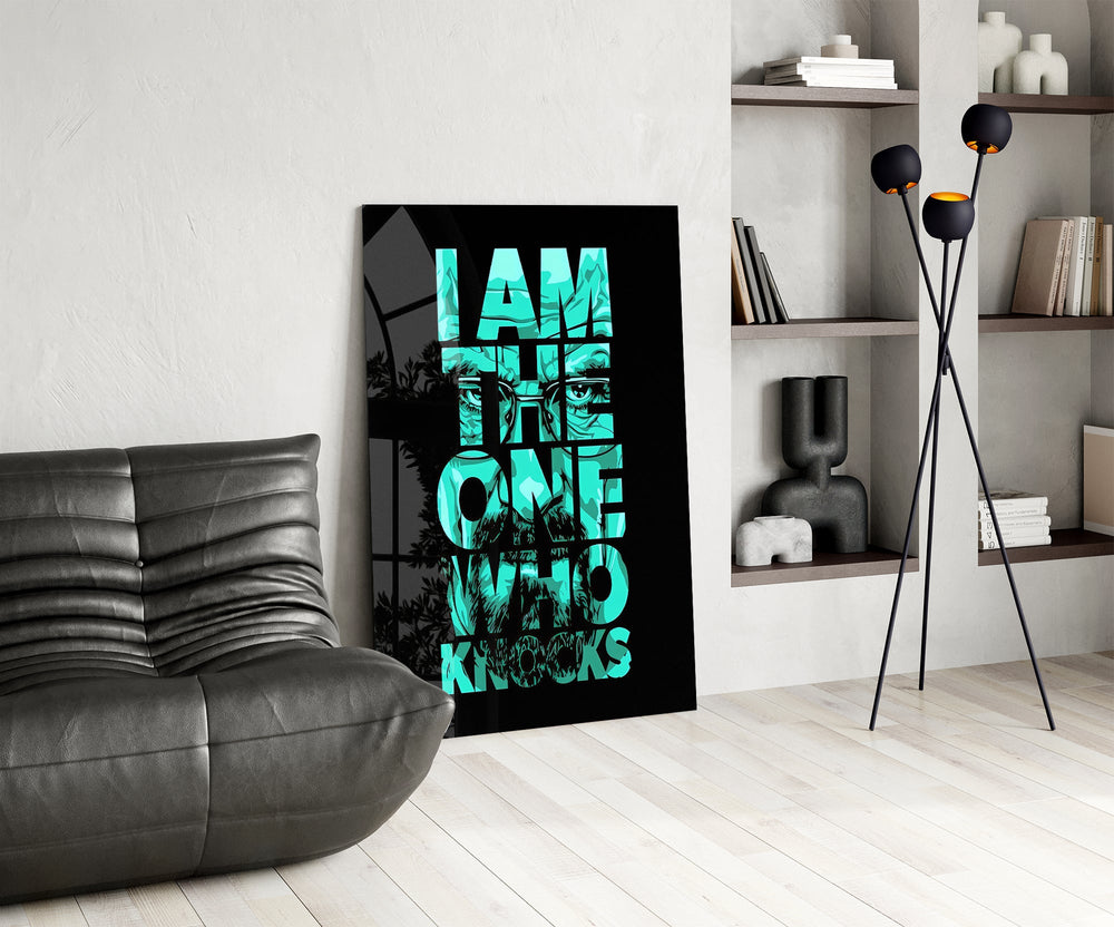 turquoise word stack hiding a face glass wall art leaning beside a dark leather sofa