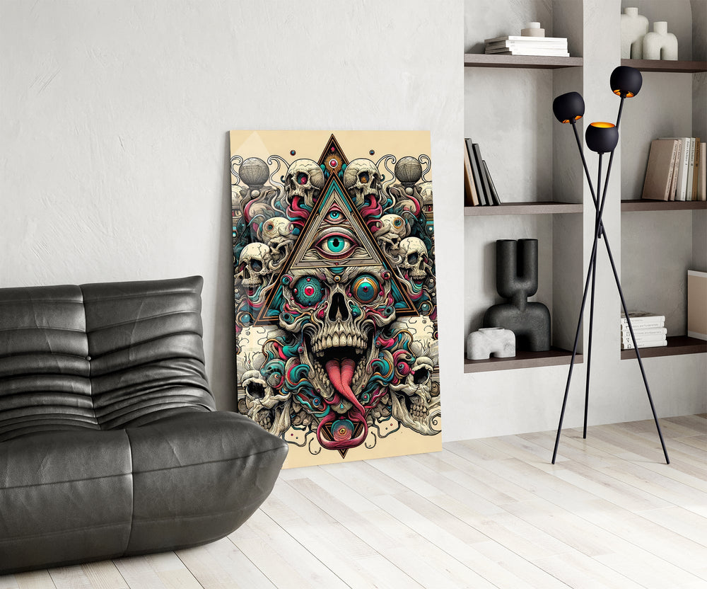 all seeing eye above a horned skull glass wall art leaning beside a dark leather sofa