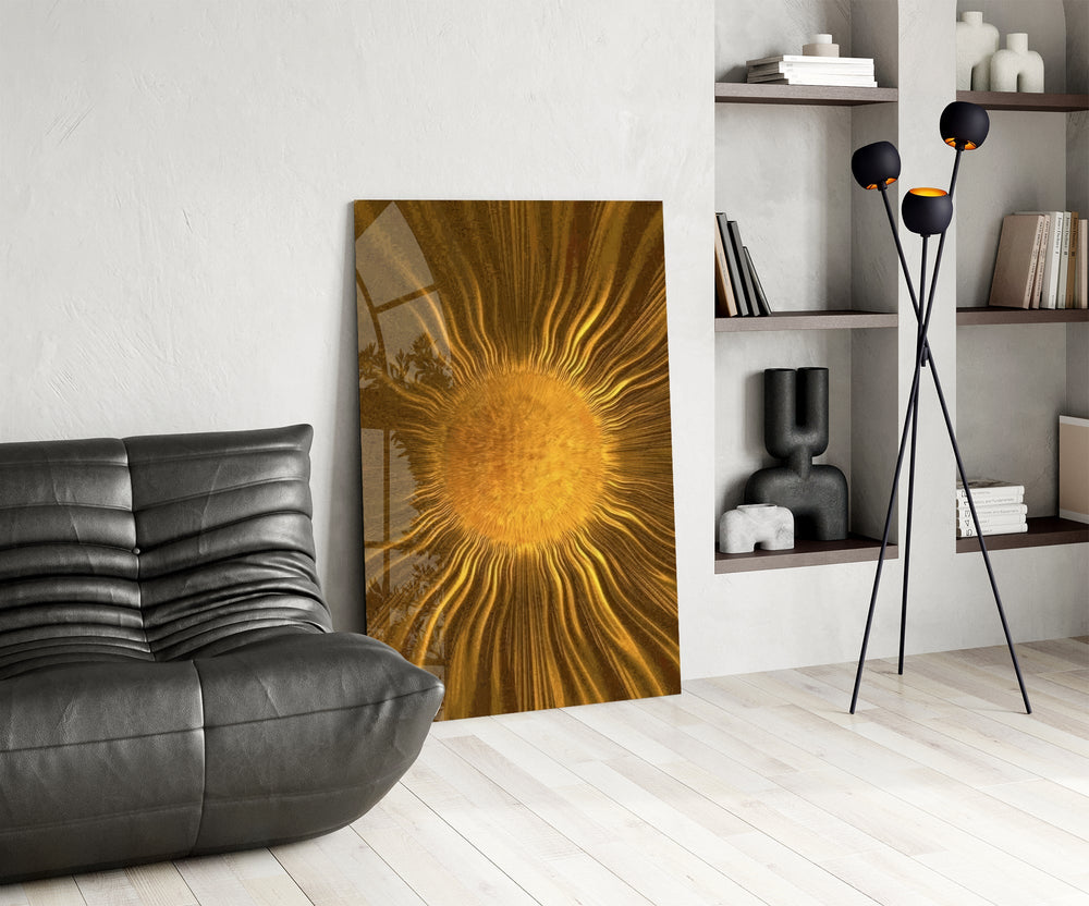 a radiant golden sunburst glass wall art leaning beside a dark leather sofa