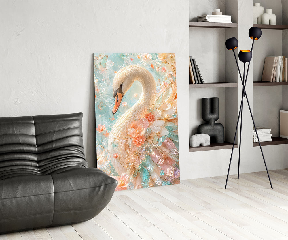 a white swan among peach and mint blossoms glass wall art leaning beside a dark leather sofa
