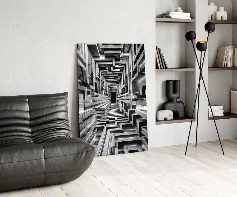 a black and white timber corridor in perspective glass wall art leaning beside a dark leather sofa