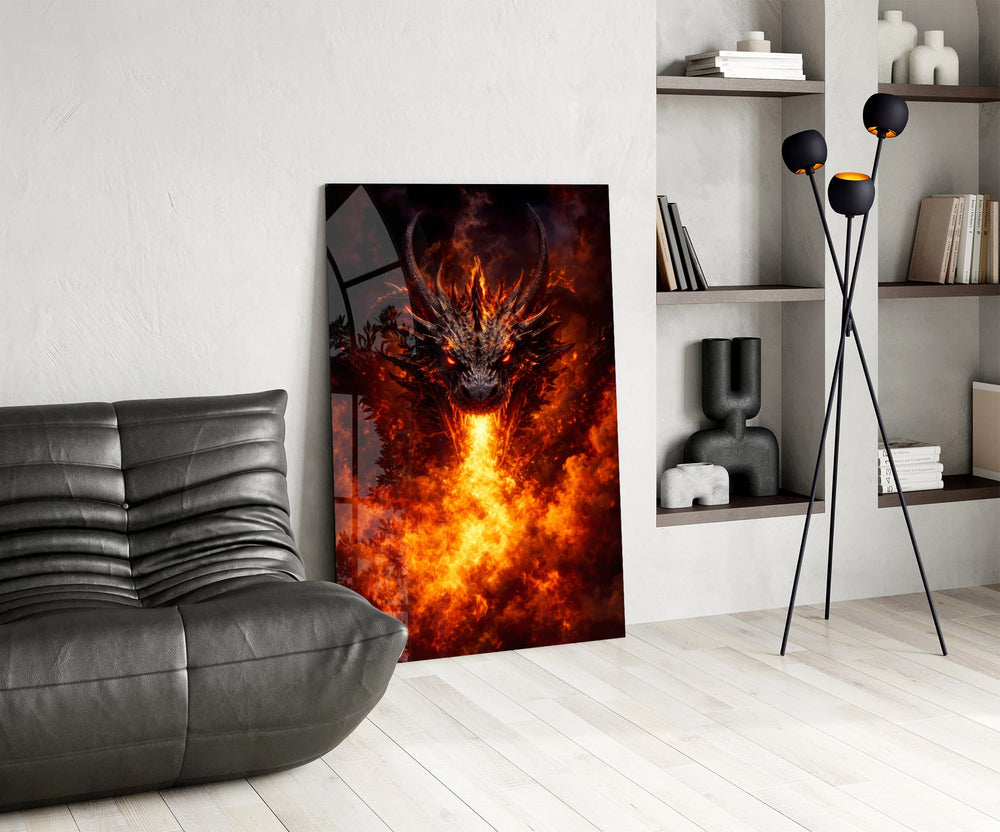 a horned dragon breathing a column of fire glass wall art leaning beside a dark leather sofa