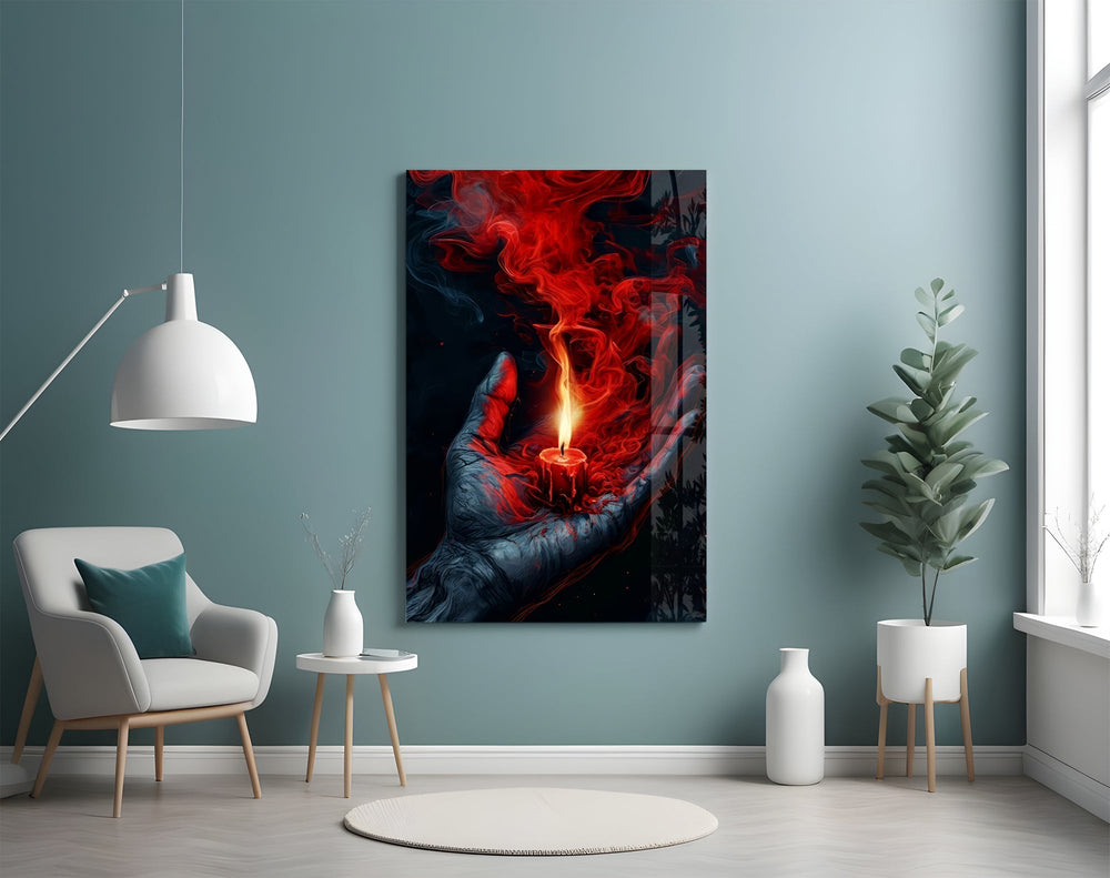 a cupped hand holding a burning red candle glass wall art styled above an armchair in a reading corner