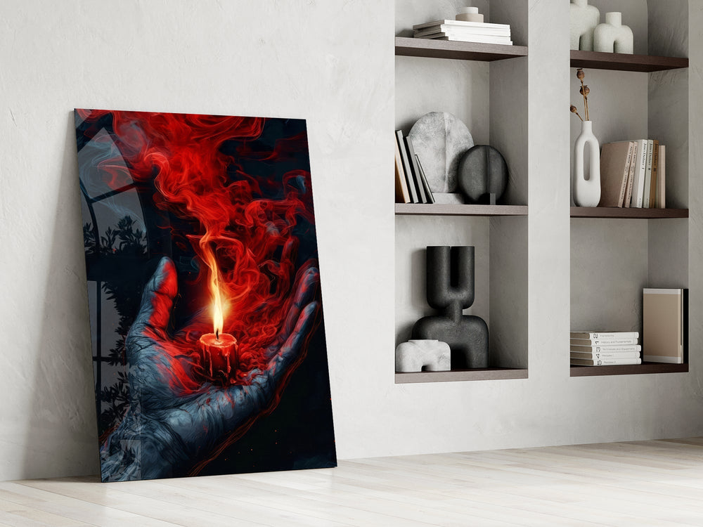 a cupped hand holding a burning red candle panel resting in a shelving niche in a modern interior