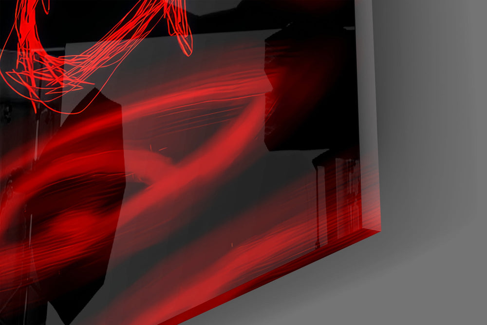 Close-up detail of the scribbled letterforms and the blurred red eyes behind them on the glass surface