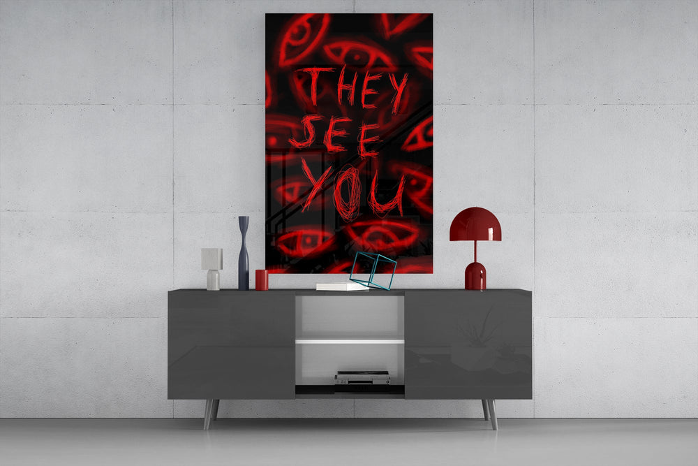 a red handwritten warning over watching eyes glass wall art displayed above a console in a designer interior
