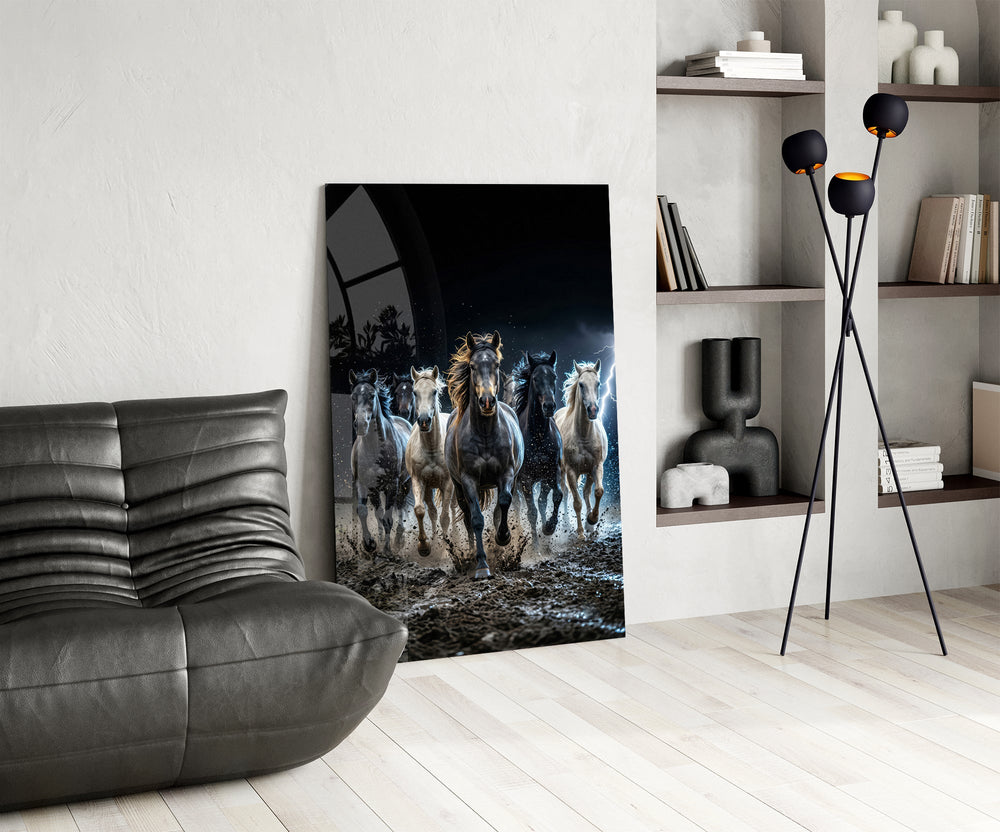a herd of horses galloping through a storm glass wall art leaning beside a dark leather sofa