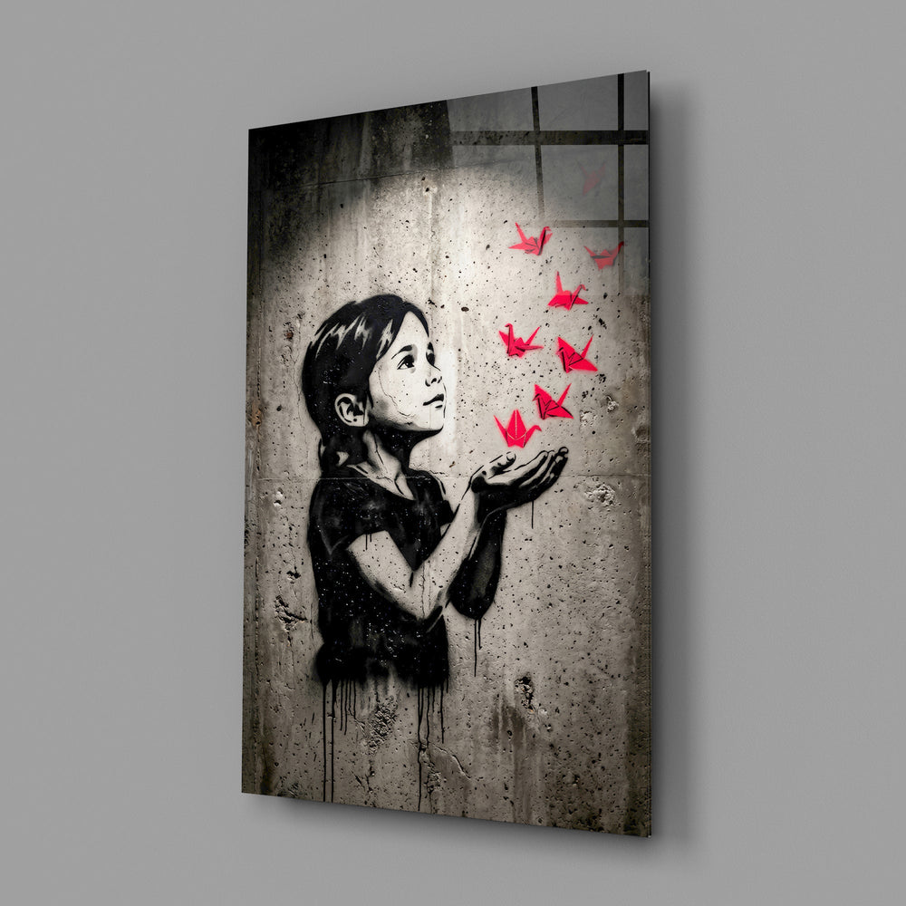 stencil girl releasing red paper cranes glass wall art angled to show the polished tempered glass panel