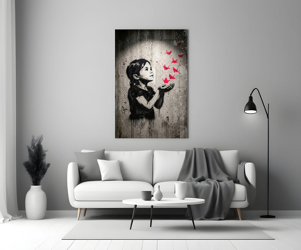 stencil girl releasing red paper cranes panel bringing character to a minimalist living room wall