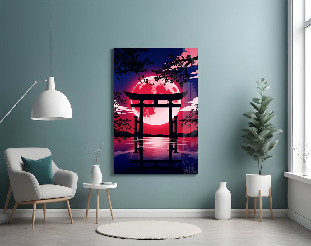 a torii gate before a crimson moon glass wall art styled above an armchair in a reading corner