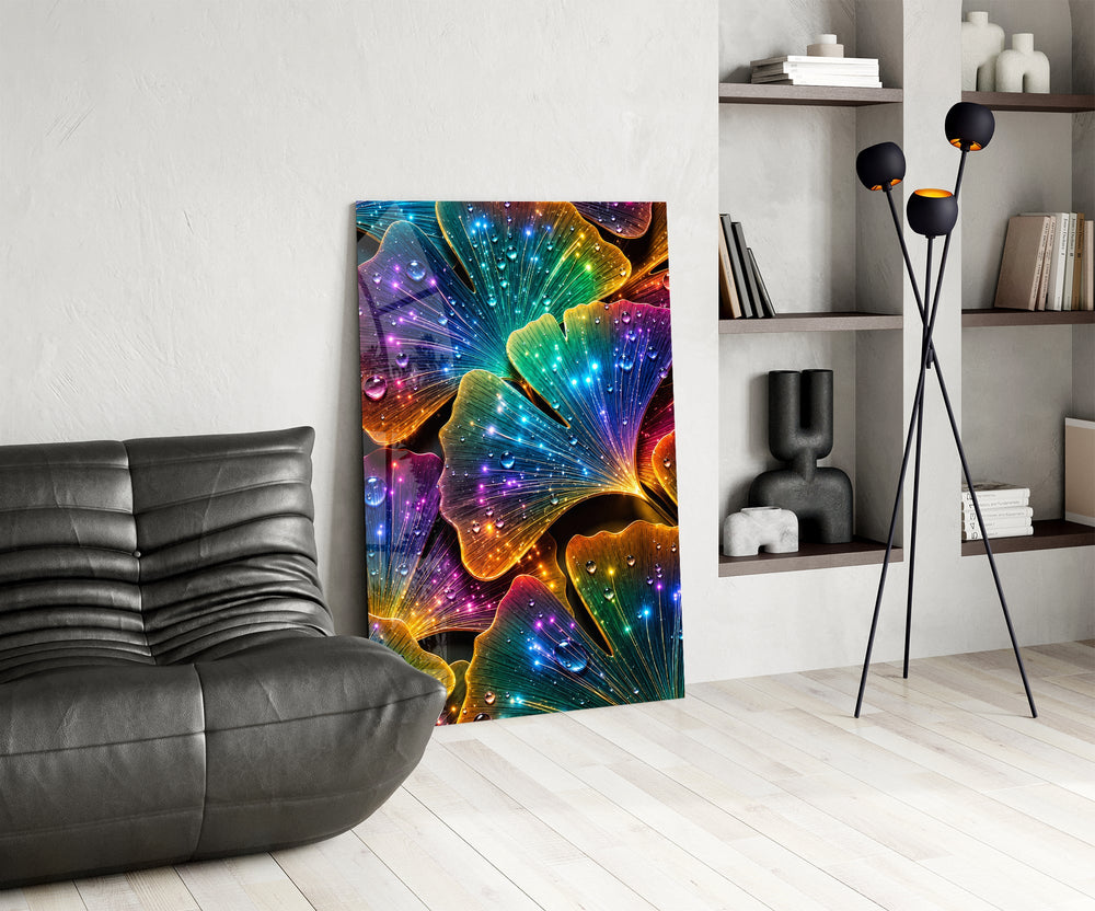 rainbow neon ginkgo leaves with dewdrops glass wall art leaning beside a dark leather sofa