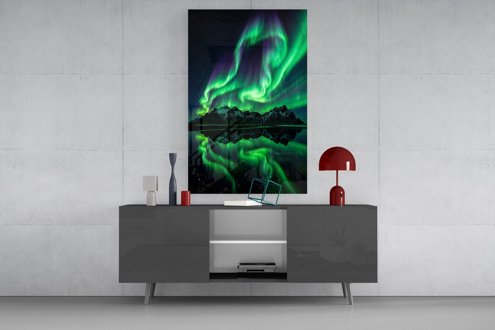 a green aurora over mirrored peaks glass wall art displayed above a console in a designer interior