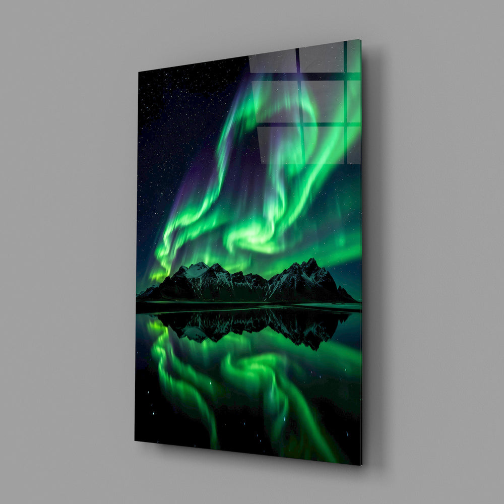 a green aurora over mirrored peaks glass wall art angled to show the polished tempered glass panel
